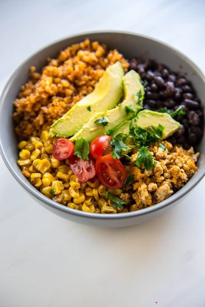Turkey Taco Bowls with Cauliflower Rice is a healthy low-carb meal that is quick and easy to prepare and makes great leftovers! #turkey #groundturkey #blackbeans #cauliflowerrice #cauliflower #lowcarb #wholefoods #healthyrecipe #cleaneating