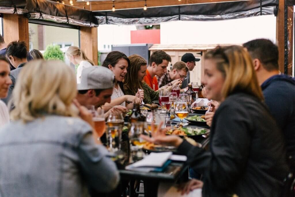 A group of people at a restaurant eating a meal together