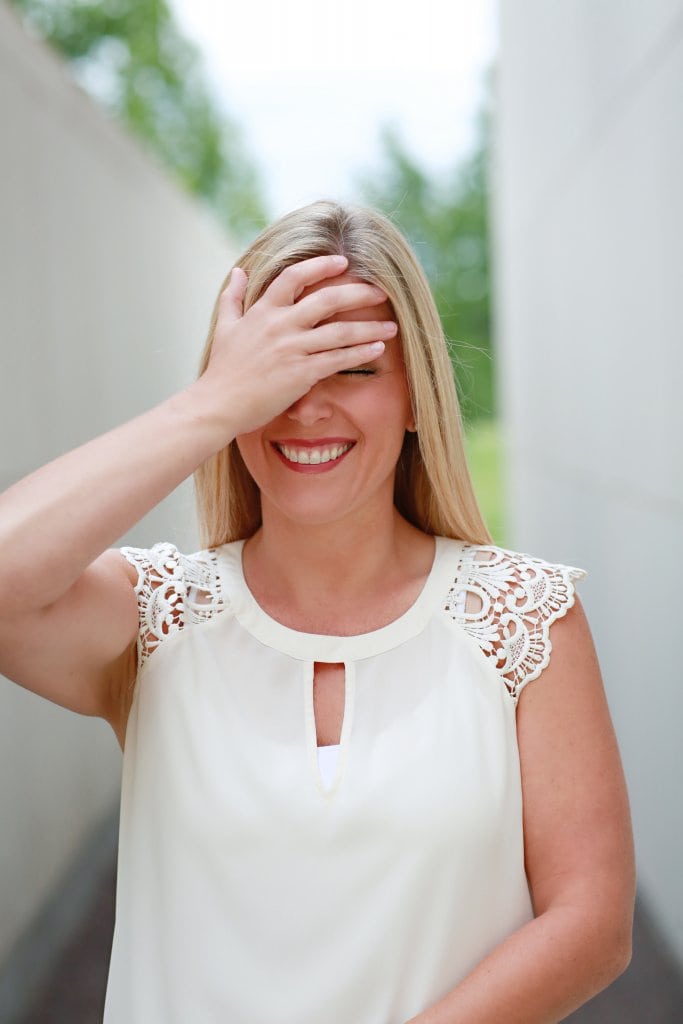 A girl holding her face and laughing