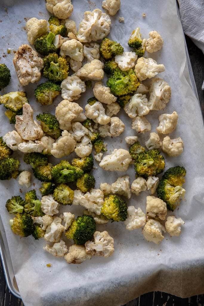 A large baking sheet with roasted broccoli and cauliflower