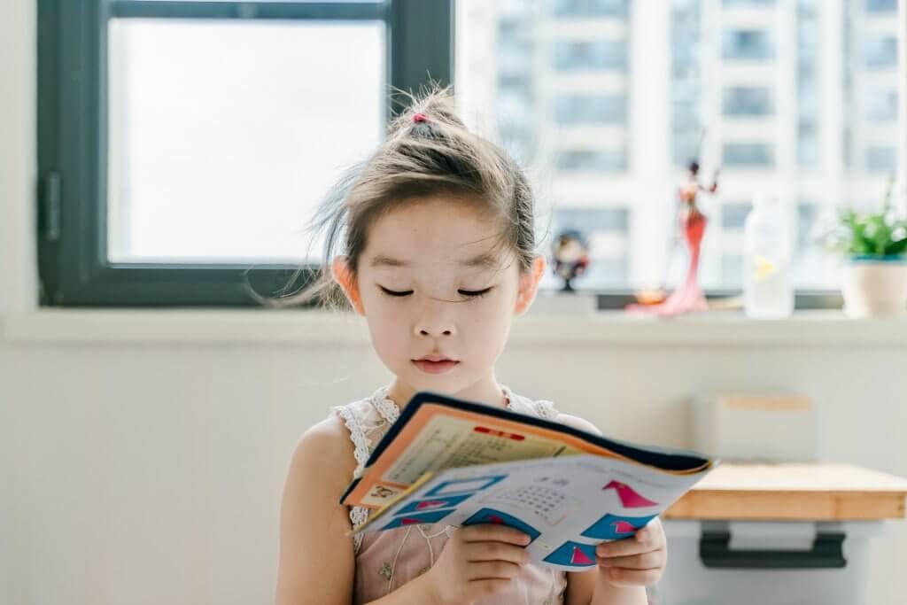 A little girl reading a book