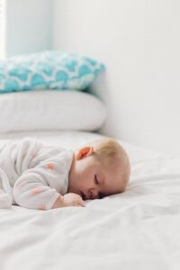 Baby sleeping on a bed