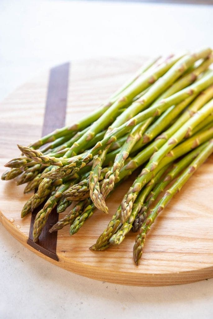 Asparagus on a wooden cutting board
