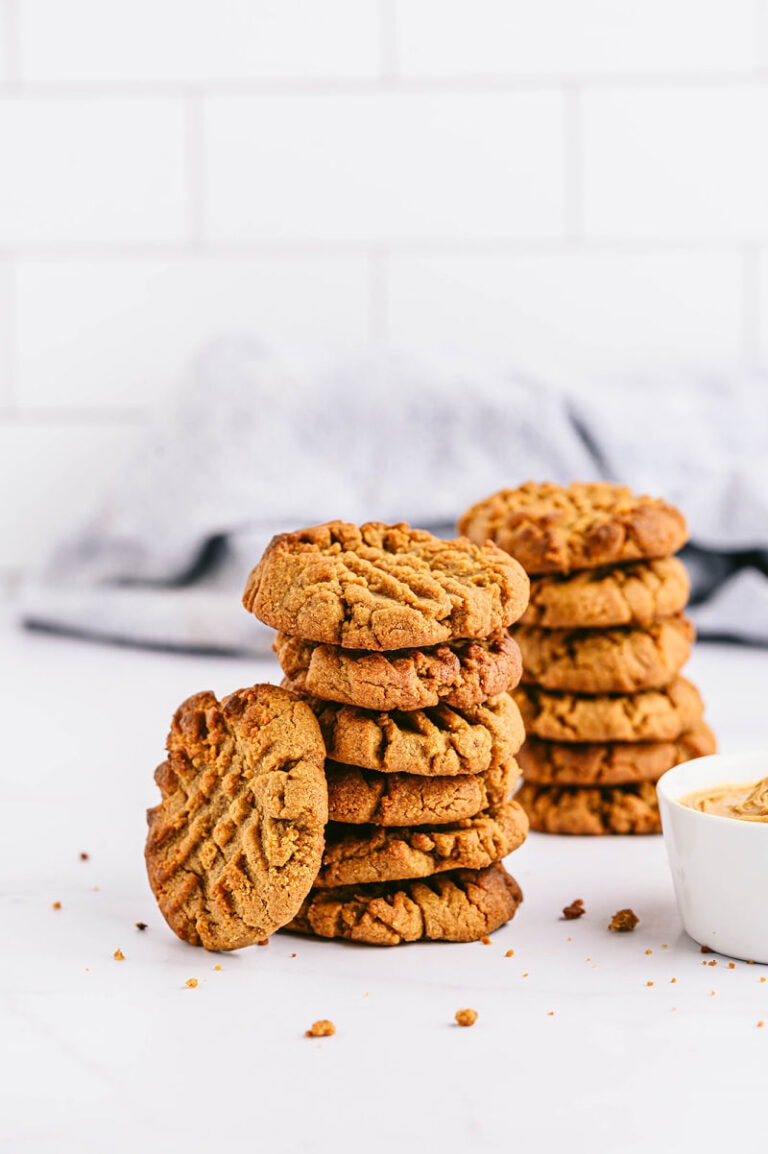 Two stacks of peanut butter cookies on a white background