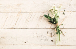 shiplap with a bundle of flowers on the right side