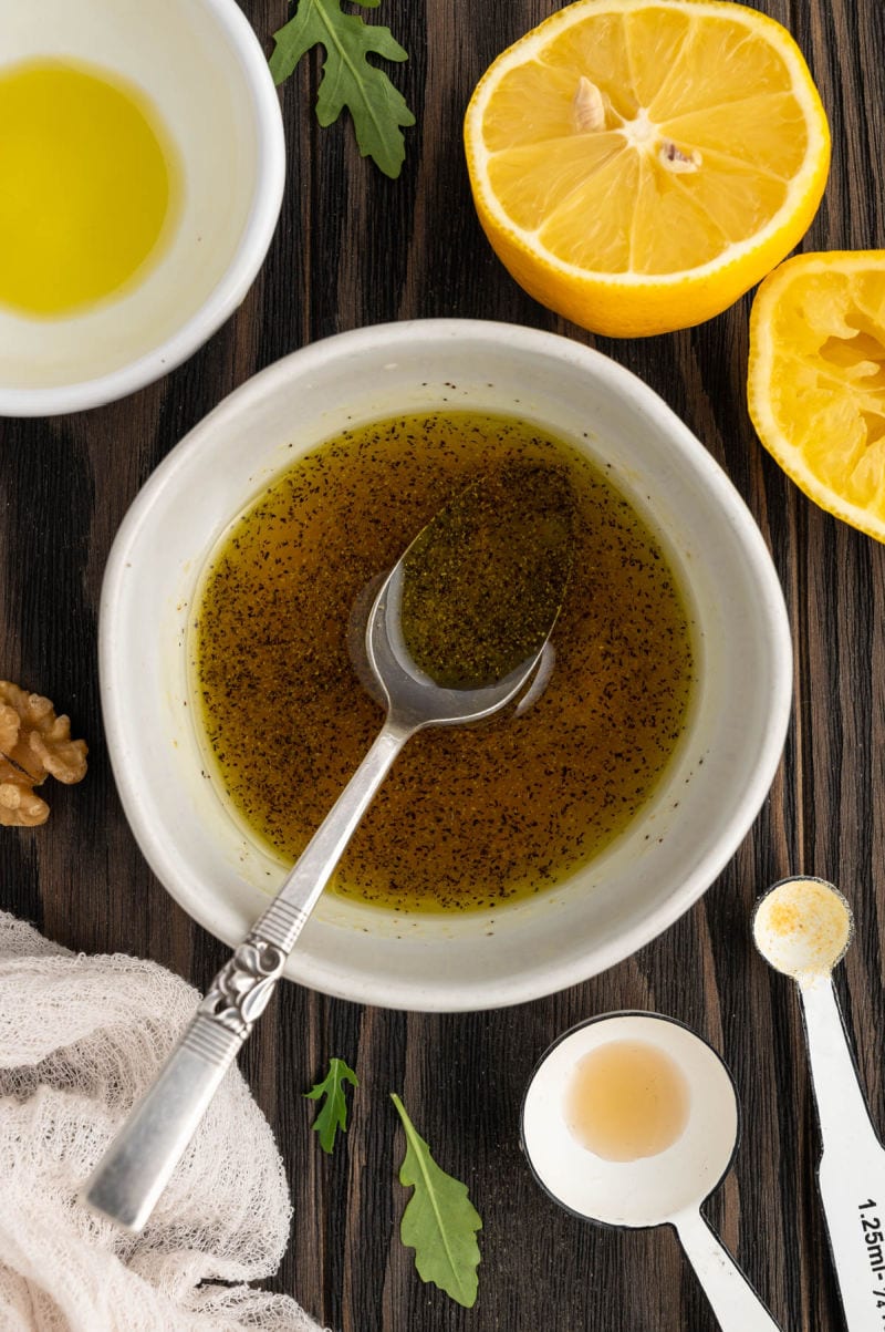 olive oil in a bowl with lemon juice and spices to make a dressing