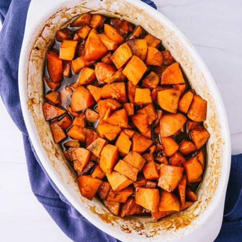 a white baking dish filled with candied sweet potatoes