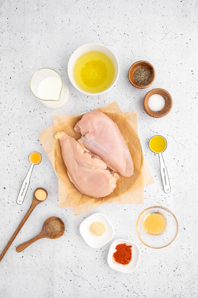 raw chicken with all the ingredients for the chicken marinade