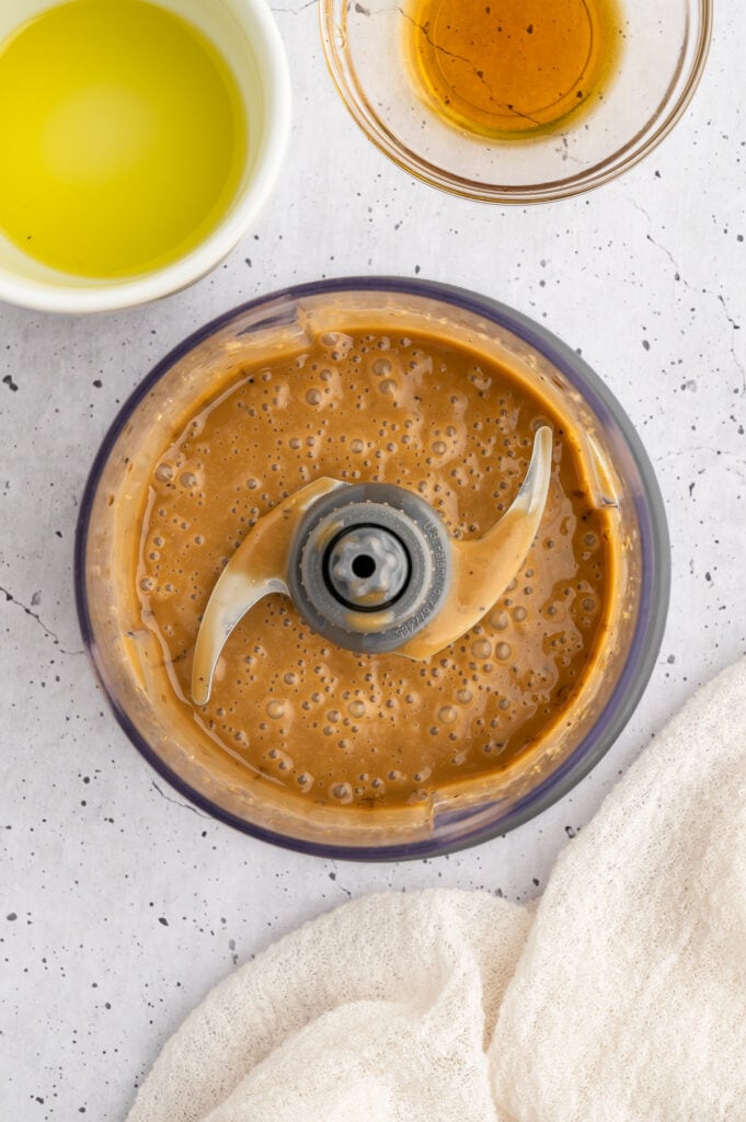 all the ingredients for creamy balsamic dressing in the food processor mixed together