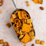 a silver spoon filled with gluten-free chex mix